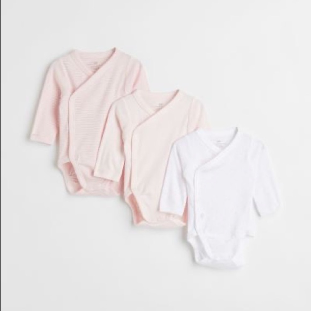 Three pack newborn kimono style long sleeve shirts. Never worn washed once.